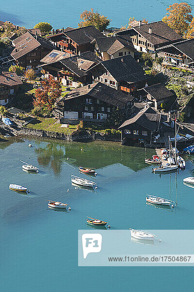 Boats in lake by village at Interlaken  Switzerland
