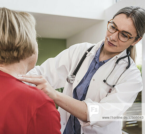 Healthcare worker checking patient's neck at home