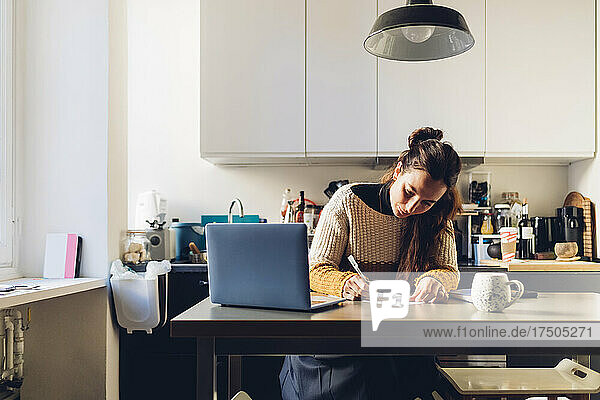 Businesswoman with laptop working at home office