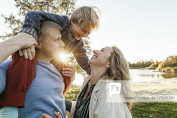 Happy family enjoying sunset at park