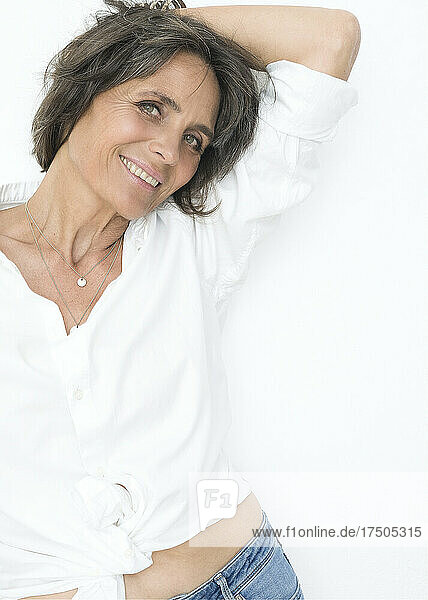 Mature woman with short hair against white background