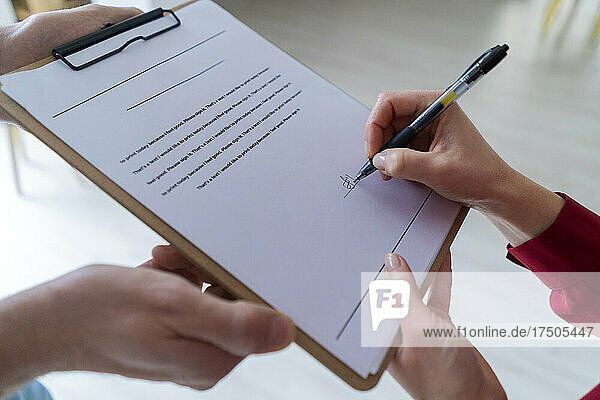 Businesswoman signing contract in office