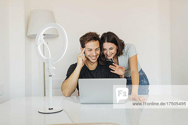 Young freelancer couple working together on laptop in home office
