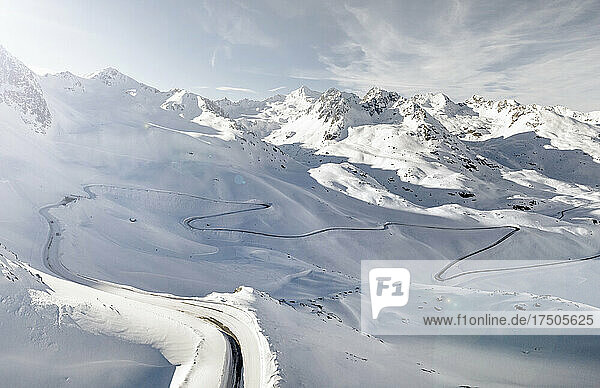 Aerial view of winding road stretching across snowcapped Kaunertal valley