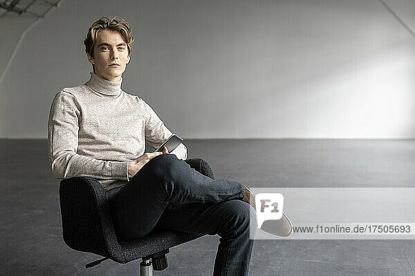 Handsome businessman sitting on office chair