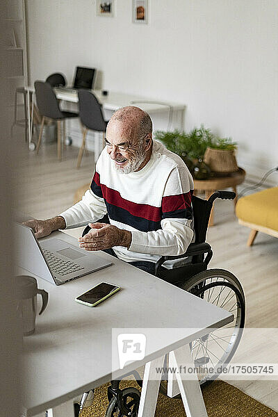 Smiling businessman with physical disability working at home