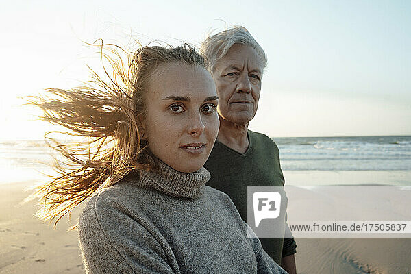 Young woman with father at beach