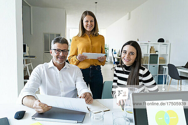 Smiling colleagues in modern office