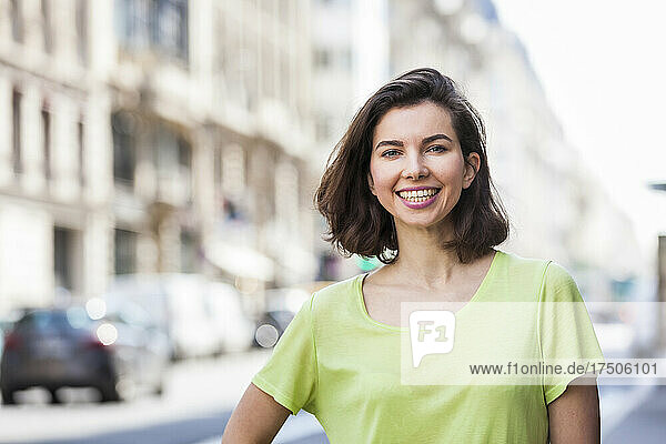 Happy beautiful woman with short hair in city