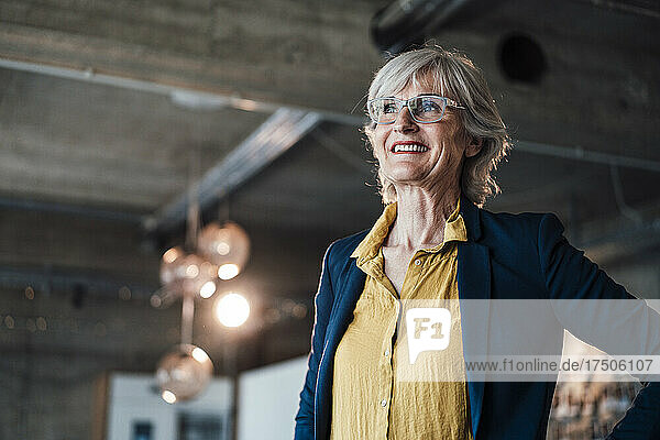 Smiling businesswoman with eyeglasses at office