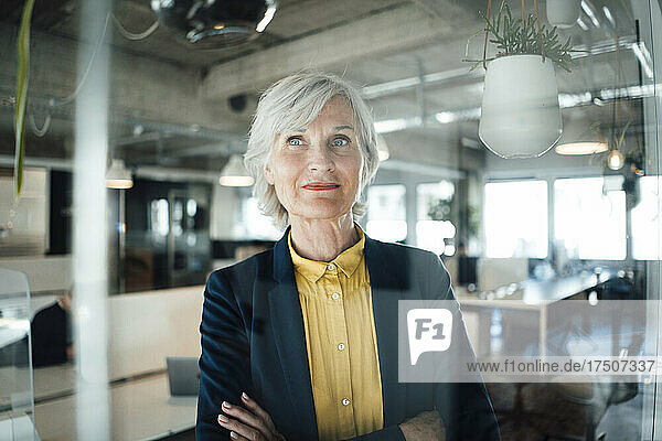 Senior businesswoman with arms crossed in office