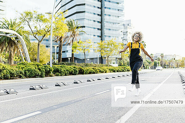Carefree woman walking on road