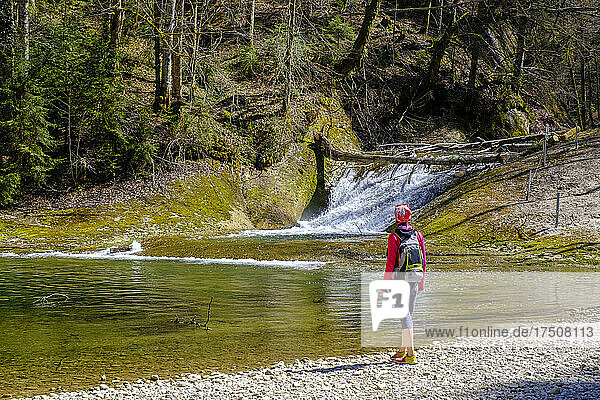 Backpacker standing at Obere Argen river  Swabia  Bavaria  Germany