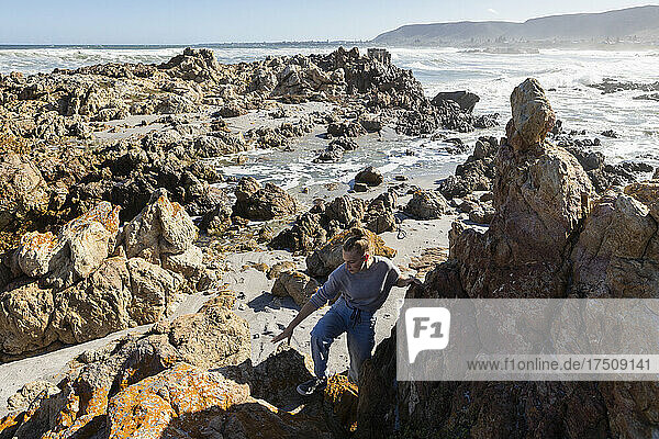 Two children exploring the jagged rocks and Atlantic coastline.