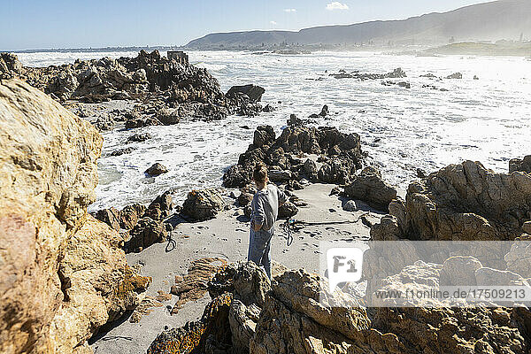 Two children exploring the jagged rocks and Atlantic coastline.