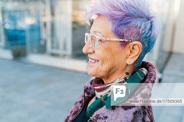Italy  Smiling fashionable senior woman with purple hair