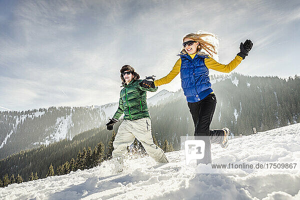 Carefree couple running through the snow  Achenkirch  Austria
