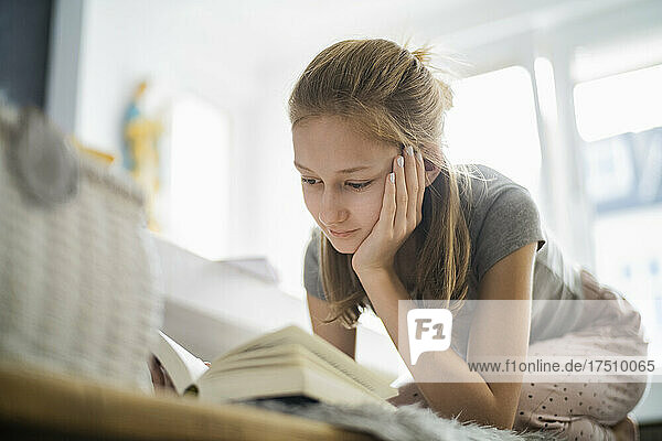 Girl reading a book at home
