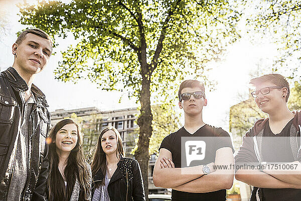 Portrait of group of friends hanging out in an urban setting