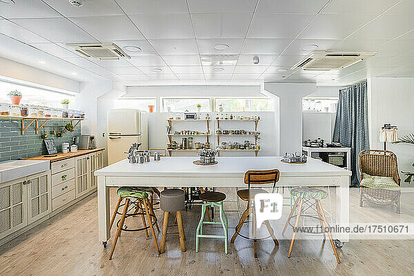 Seats arranged at kitchen island in cooking school