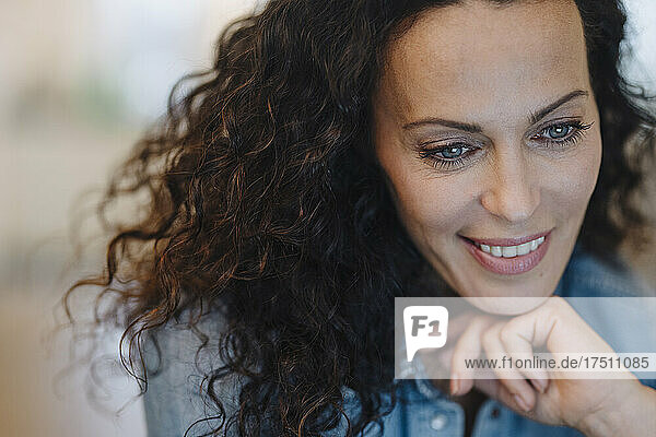 Smiling woman looking at device screen