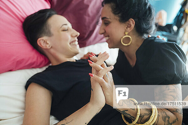 Smiling lesbian couple in bedroom