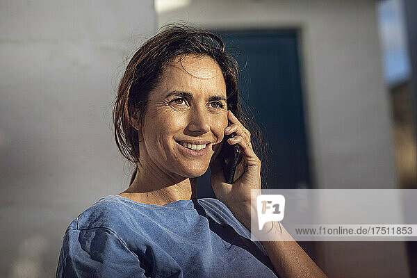 Portrait of a pretty  dark-haired woman  talking on the phone