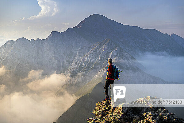 Man standing on top of mountain at Bergamasque Alps  Italy