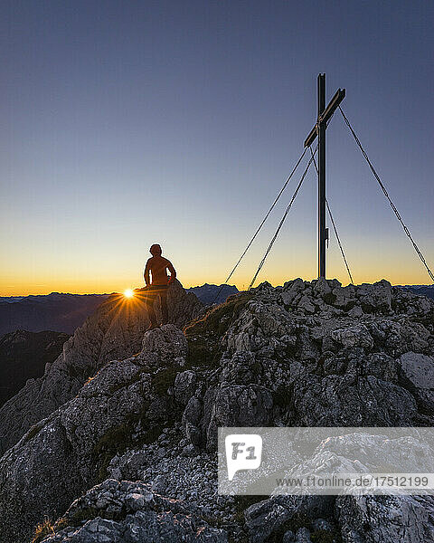 Rear view of hiker standing on viewpoint during sunrise  Gimpel  Tyrol  Austria
