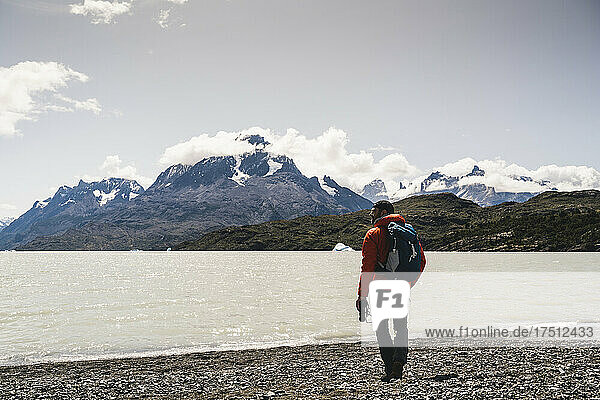 Man holding binocular while hiking at Torres Del Paine National Park  Chile  Patagonia  South America