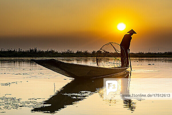 Myanmar  Shan state  Silhouette of traditional Intha fisherman on Inle lake at sunset