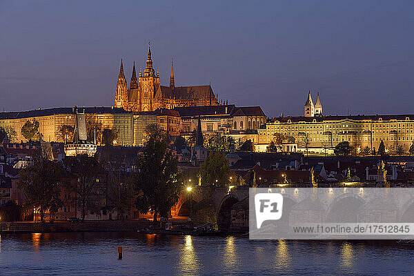 Czech Republic  Prague  Charles Bridge stretching over Vltava river at dusk with Prague Castle looming in background