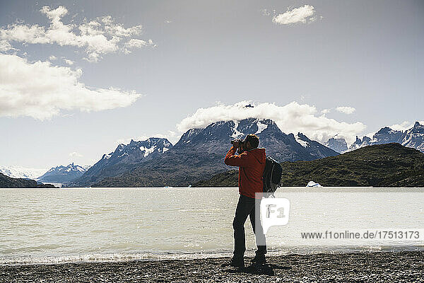 Man using binocular during hiking at Torres Del Paine National Park  Patagonia  Chile  South America