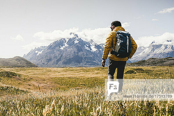 Man with backpack hiking at Torres Del Paine National Park in Patagonia  South America