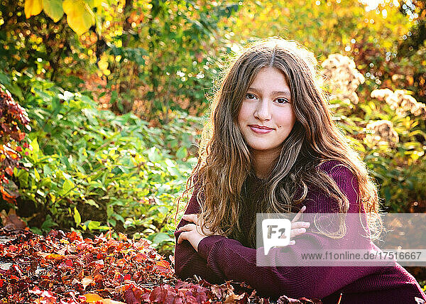 Beautiful smiling tween girl outdoors in fall colors.