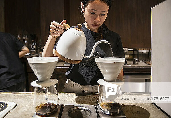 Barista preparing drip coffee at slow coffee bar in Bangkok