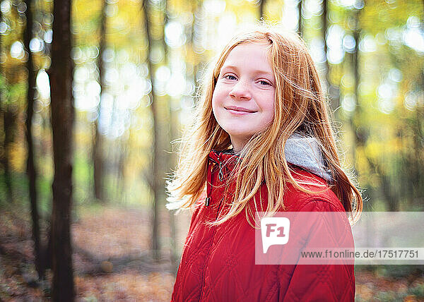 Red Haired Tween Girl Hiking in the Fall woods.