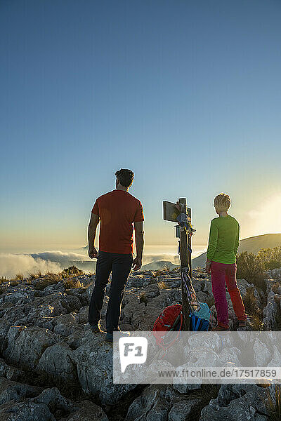 Couple hiking on Oltá mountain  Calpe  Alicante  Spain