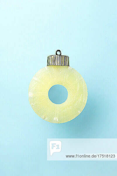 Christmas bauble decoration of pineapple on blue. New year concept.