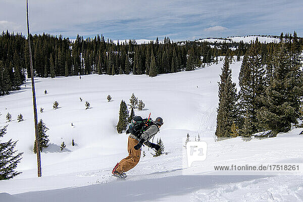Male Snowboarder riding snow in colorado backcountry