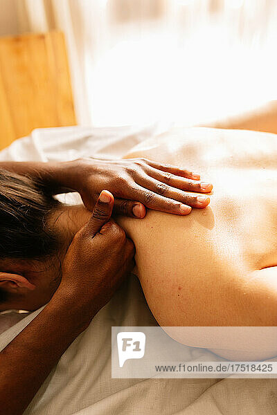 Hands of african american professional therapist giving a massage