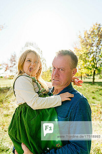 Funny portrait of a father and daughter making silly faces