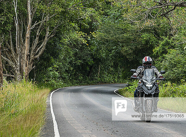 man riding his adventure motorcycle at Khao Yai national park