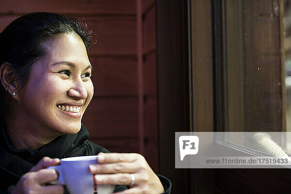 woman enjoying a hot beverage at cafe in France