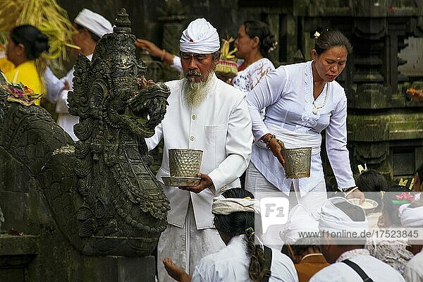 Devout Hindus at a ceremony in the temple  Pura Goa Lawah  Bali. Indonesia