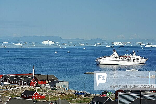 Houses and public buildings  cruise ship in a bay with icebergs  Ilulissat  Disko Bay  Arctic  Greenland  Denmark  North America