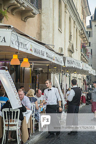 Waiter and outdoor cafe tables  Piazza Navona  Rome  Lazio  Italy  Europe
