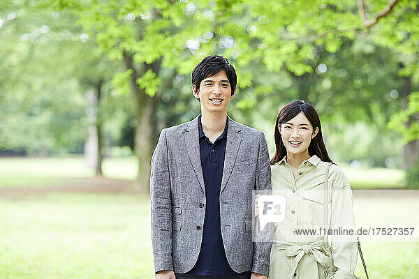 Japanese Couple Taking A Walk In The Park