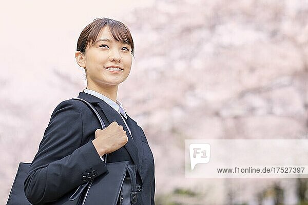 Japanese Woman In A Suit And Cherry Blossoms