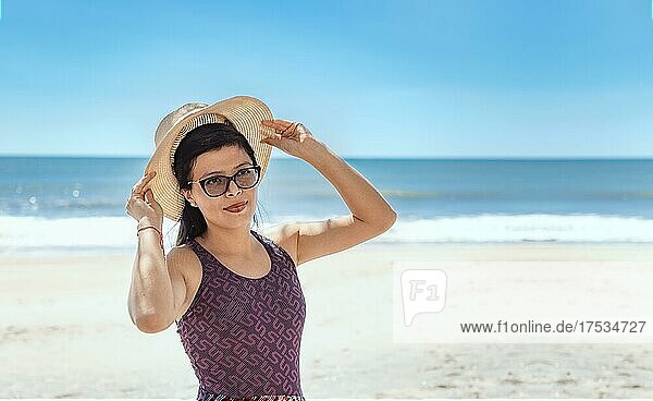 Woman in hat happy on the beach  happy pretty young woman on vacation  vacation concept